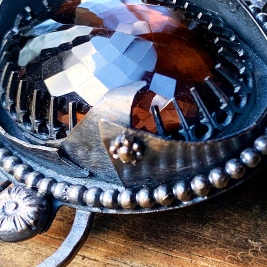 In this photo is a beautiful Smokey Quartz Cabochon surrounded with scrap sterling silver. This became a piece of a necklace pendant 