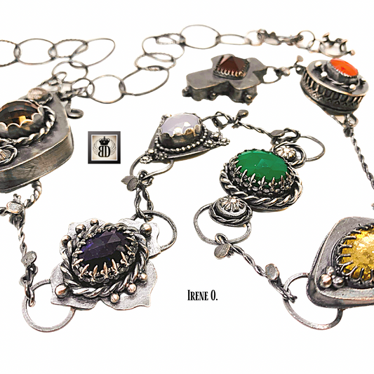 Necklace is joined together by wire to give hanging pieces movement in this gemstone chakra necklace 