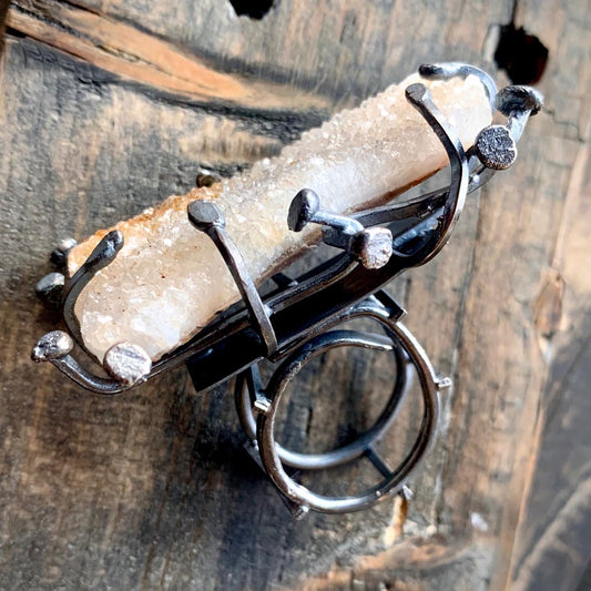 This is a sterling silver ring made with wire using a raw chunk of citrine druzy the band is designed as a ladder style. The ring band is adjustable to any size and is very comfortable. 